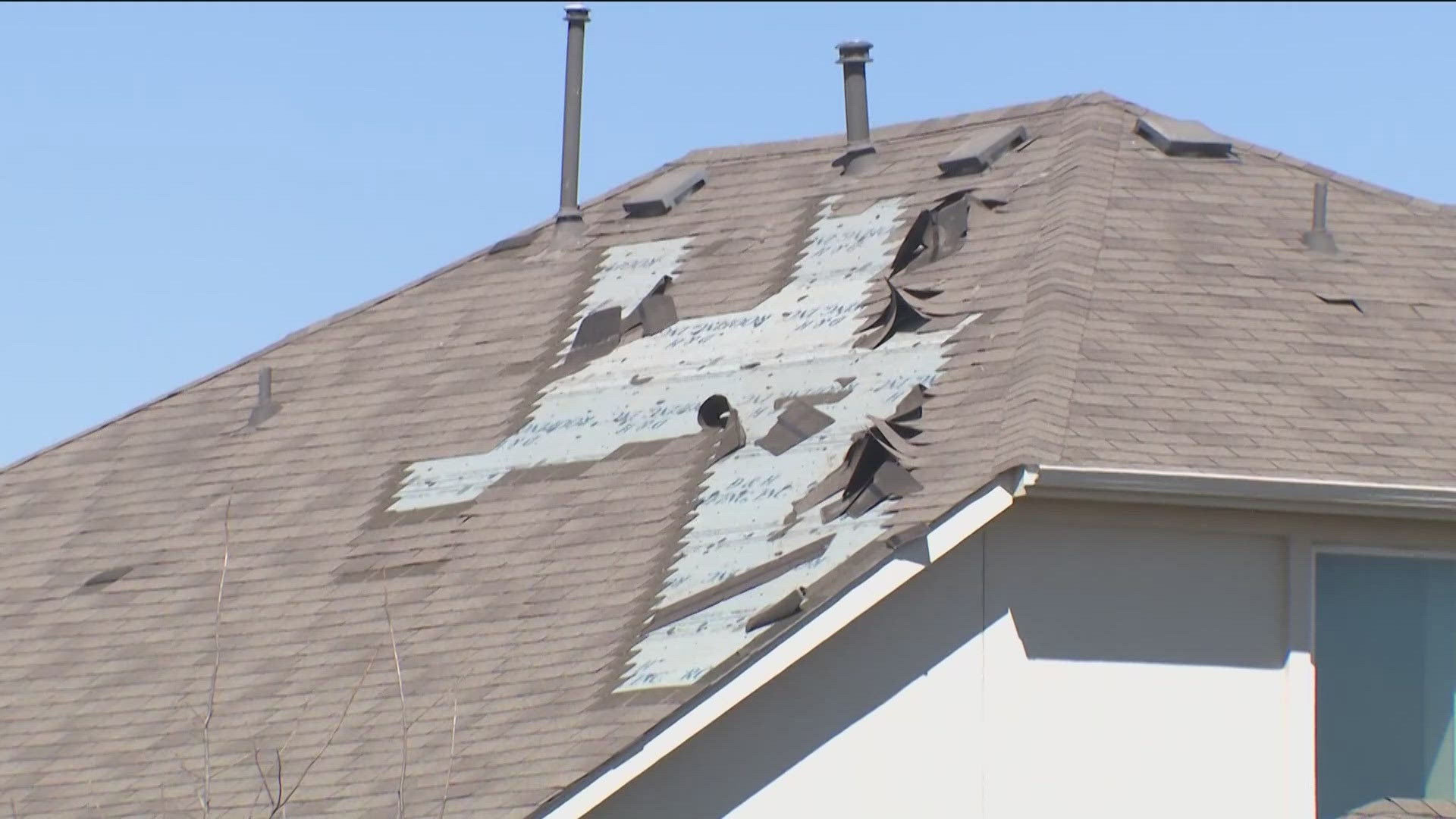 Close-up of exposed roof decking after hail and wind damage